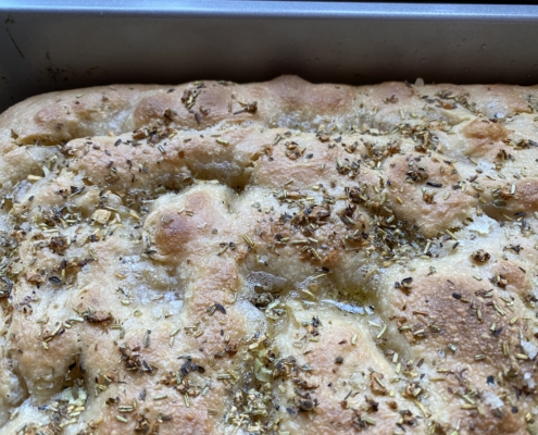 Garlic and herb sourdough ficaccia close up of corner